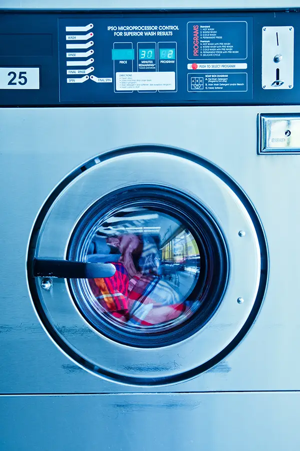 a person repairing a washing machine